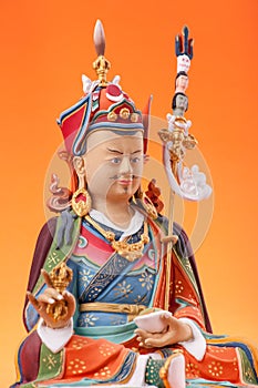 Figurine of Guru Rinpoche with dorje. photo